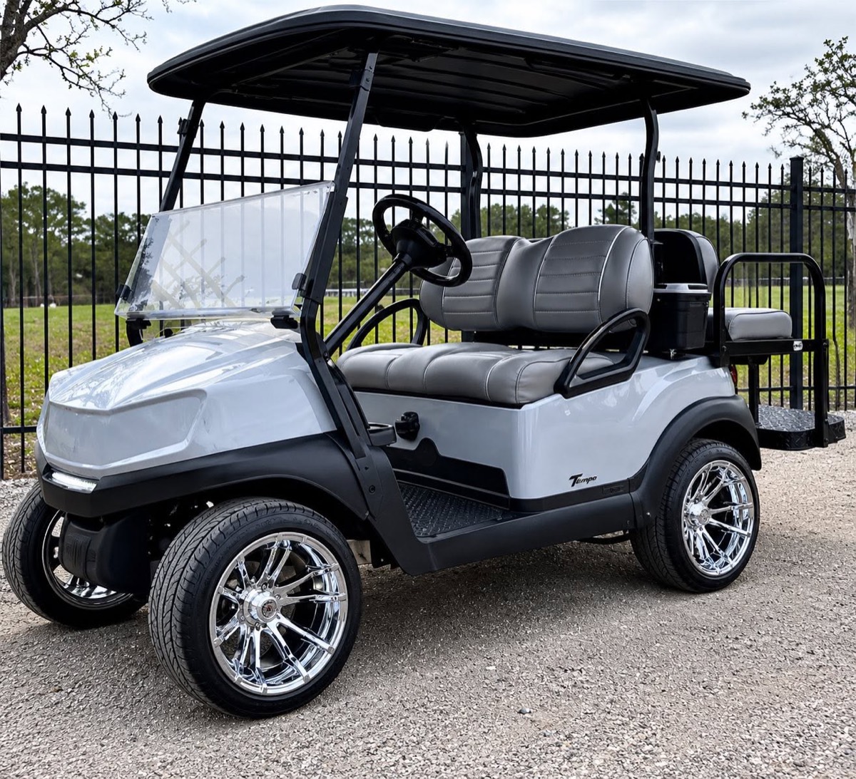 White Club Car Tempo with chrome wheels and grey upholstery