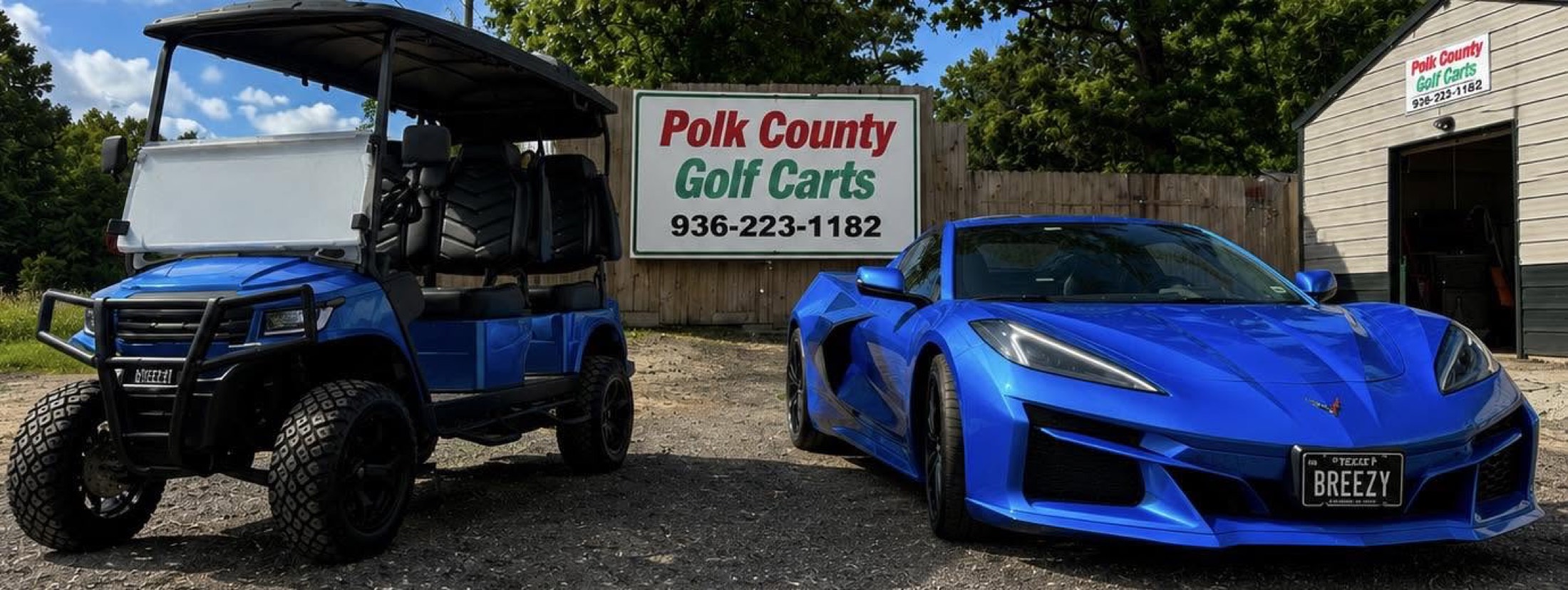 Polk County Golf Carts shop sign with a blue Breezy EV cart parked next to a blue Corvette with BREEZY license plate
